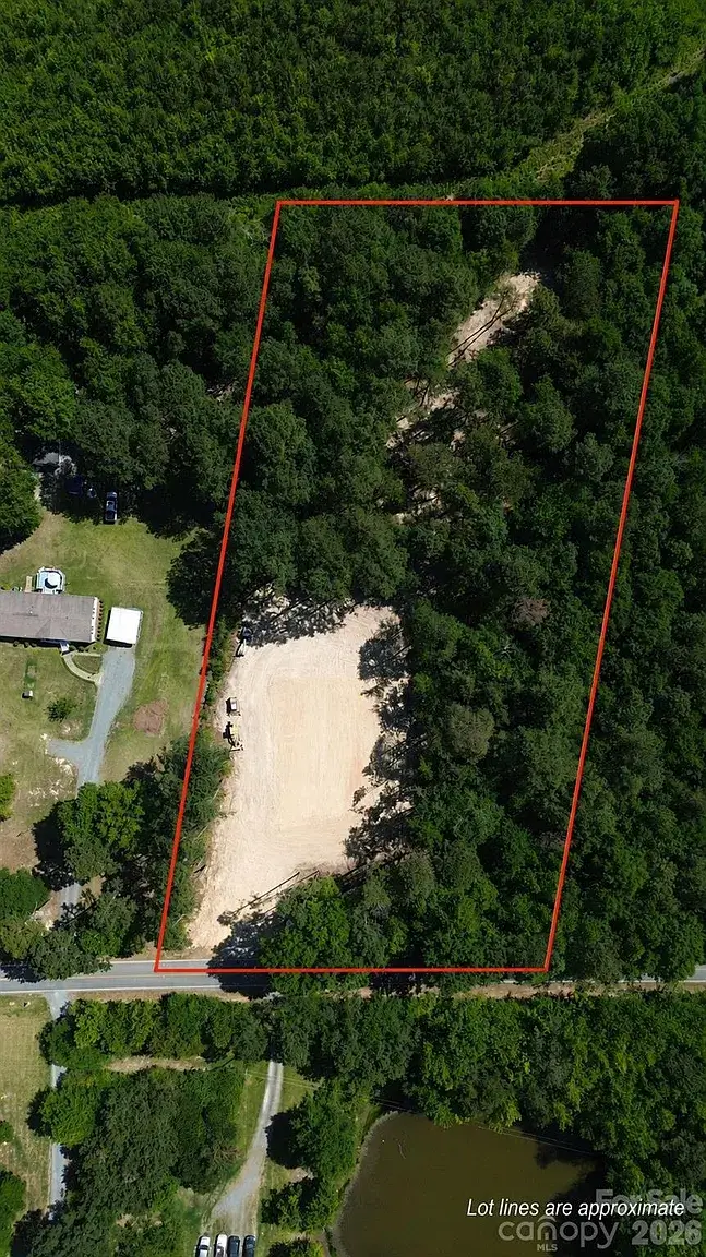 Aerial view of a wooded 2-acre lot in Monroe, North Carolina, with approximate property boundaries highlighted and cleared homesite visible.